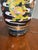Famille noir, vintage table lamp featuring a hand-painted black ceramic vase base with a colorful dragon motif on a carved...