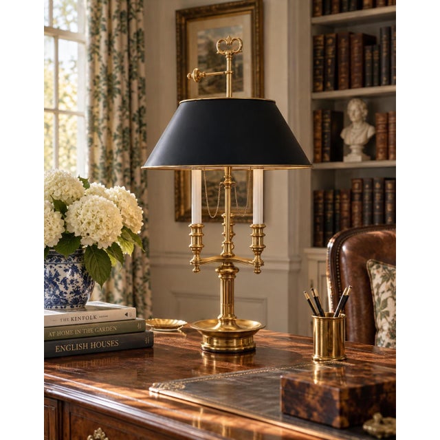 A handsome late 20th-century brass bouillotte lamp with a tailored black tole shade, drawing on the elegant proportions of...