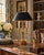 A handsome late 20th-century brass bouillotte lamp with a tailored black tole shade, drawing on the elegant proportions of...