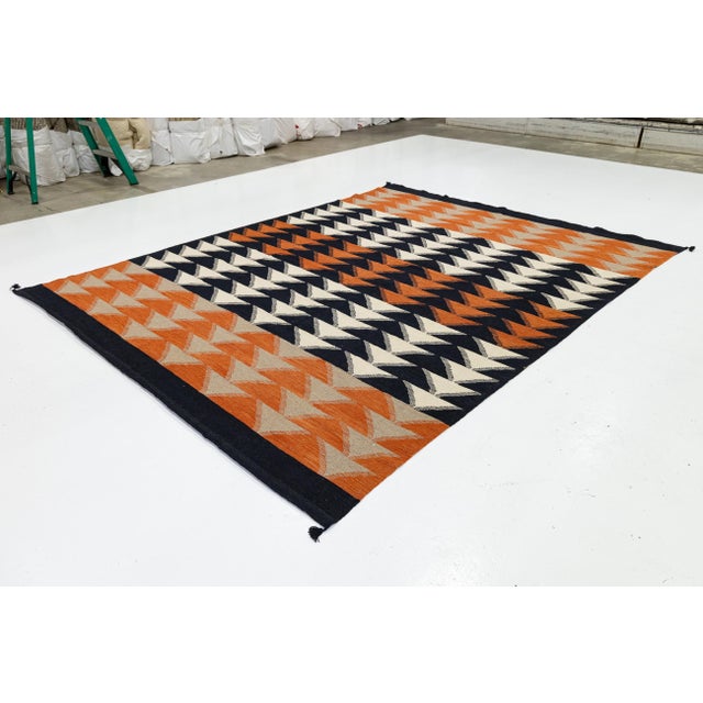 Elevate your space with this striking Modern Navajo-inspired wool rug. Featuring a rhythmic, handmade pattern of stacked...