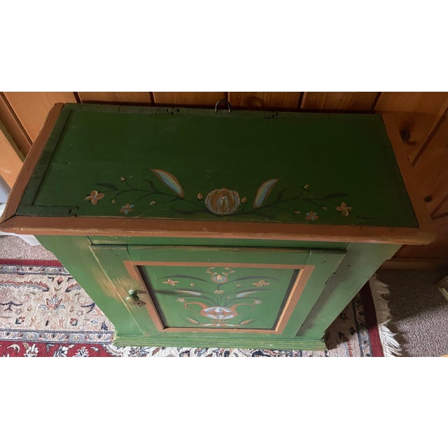This antique Eastern European hand painted cabinet has sturdy shelving inside for storage. It was imported to the US from...
