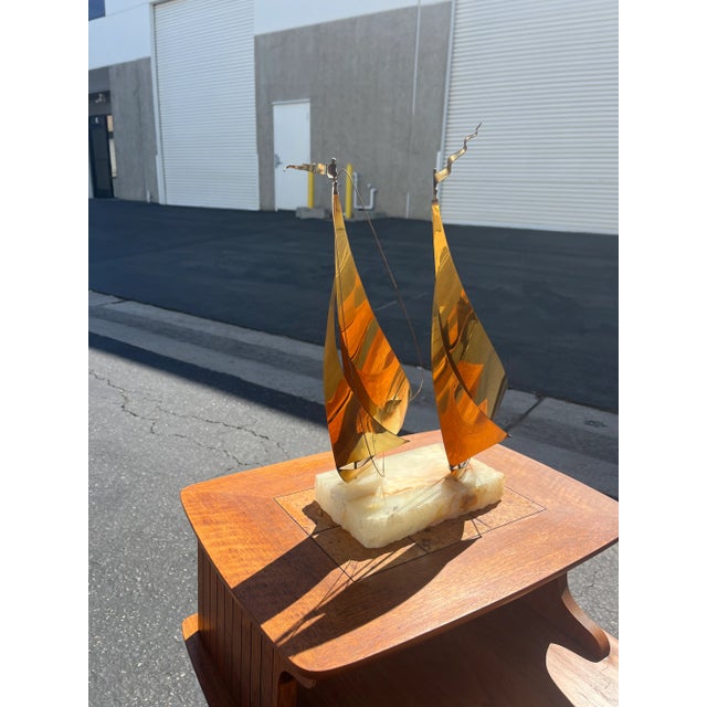 This fun piece weighs about 4 pounds.The double sailing boats are made of brass and sit on a signed marble base.It was...