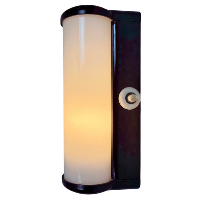 Vintage industrial dark brown bakelite wall lamp made by Elektrosvit in former Czechoslovakia during the 1950s. It...