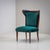 Pair of low lounge chairs featuring wingback-style backs with distinctly shaped corners. The chairs rest on tapered legs...