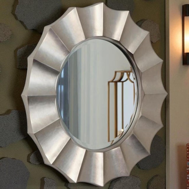 A large 41 silver-leaved modern wall mirror that's effective for adding a striking glam Hollywood Regency accent to your...