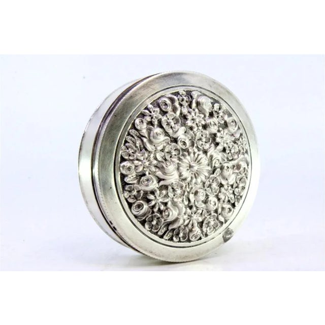 Circular Silver Box with Floral Reliefs, in Very Good conditions. Designed 1890 to 1919 This piece has an attribution...