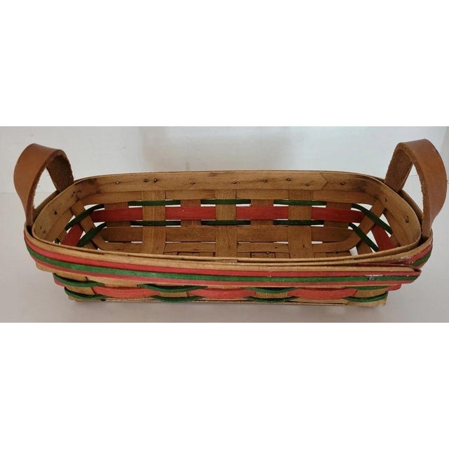 This Vintage 19th Century Handmade Holiday Basket with Leather Handles features a charming woven design accented with...