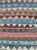 This Mid-20th century Persian flatweave kilim is defined by a richly layered field of horizontal stripes that create a...