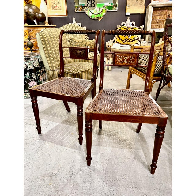 This is a very good set of 6 English Regency solid mahogany side or dining chairs of a modified klismos form. The chairs...