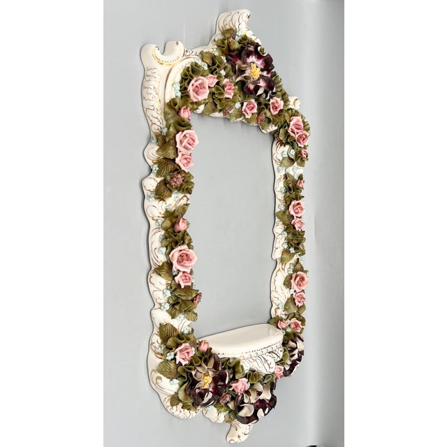 Stunningly detailed porcelain wall frame in the Capodimonte style, richly adorned with hand-applied florals in soft blush...