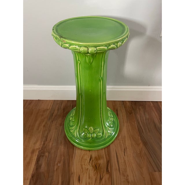 This plant stand stands out! With floral details to both base and upper tray it has an art nouveau into arts and crafts...
