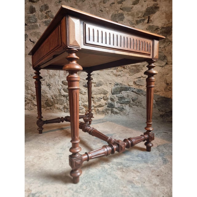 Old French writing table dating from approximately the 1930s, crafted from walnut. This compact piece features a single...