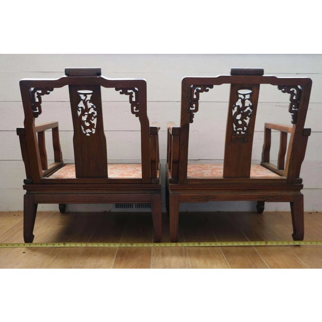 Two carved wood arm chairs. No maker marks observed. Each has an upholstered seat cushions. Each measures approximately H...