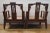 Two carved wood arm chairs. No maker marks observed. Each has an upholstered seat cushions. Each measures approximately H...