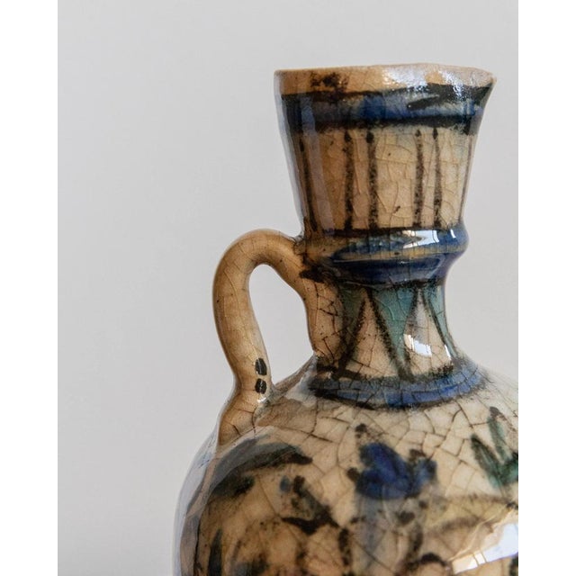 This antique 18th century ceramic vase is a delicate handcrafted piece from the Near East, featuring a beautifully hand-...