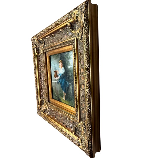 A beautifully detailed European-style genre painting housed in an ornate gilt carved frame, featuring a seated young woman...