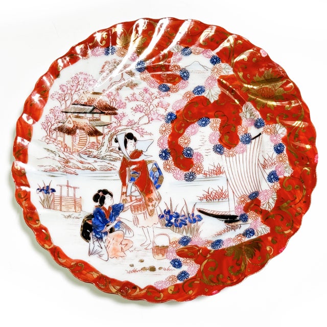 A beautiful set of four vintage Japanese Geisha Girl porcelain plates featuring richly detailed scenes of kimono-clad...