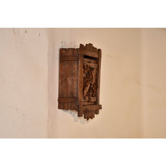 19th century Black Forest small hanging wall box. The entire piece is hand carved to have the appearance of boards with...