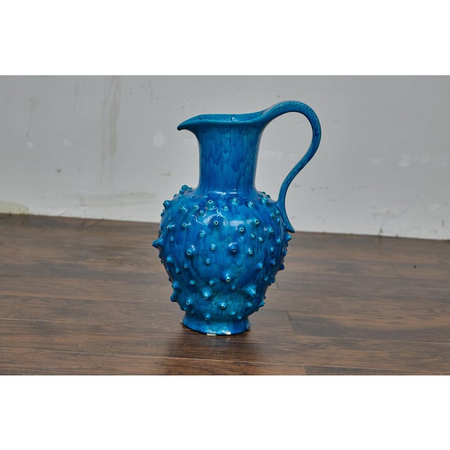 This striking French Vallauris pottery pitcher, crafted around the 1950s, showcases the bold creativity that defined mid-...