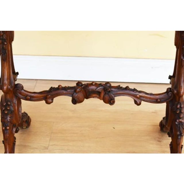 For sale is a very good quality Victorian Burr Walnut Stretcher Table with an elaborately carved base. The top of the...