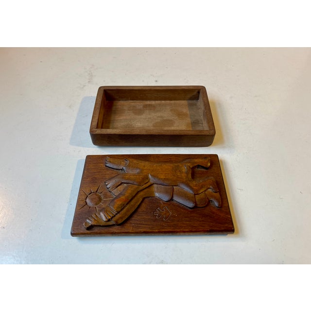 Unusual decorative box for cigars or personal smalls. It hand-tooled and features a hand-carved lid in solid oak. The...