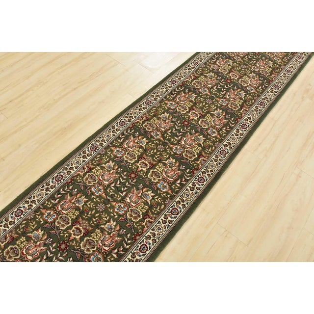 An authentic vintage traditional Sarouk runner hand-knotted with fine wool and natural dyes. This intricately woven rug...