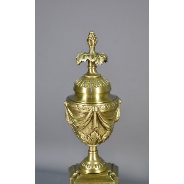 An attractive pair of French bronze fire dogs dating from the 19th century, Empire / Napoleon III period. Finely cast in...