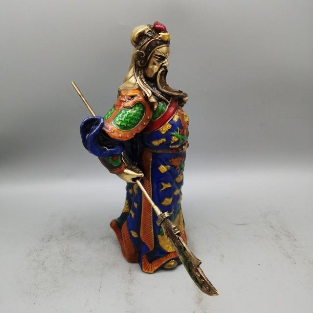 This striking standing statue depicts Guan Gong, the revered Chinese warrior deity, holding his signature guan dao blade....