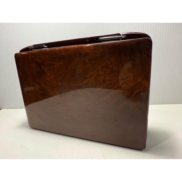 Authentic 1950s RCA Victor B-411 portable tube radio featuring classic atomic-era mid-century styling. With its sculptural...