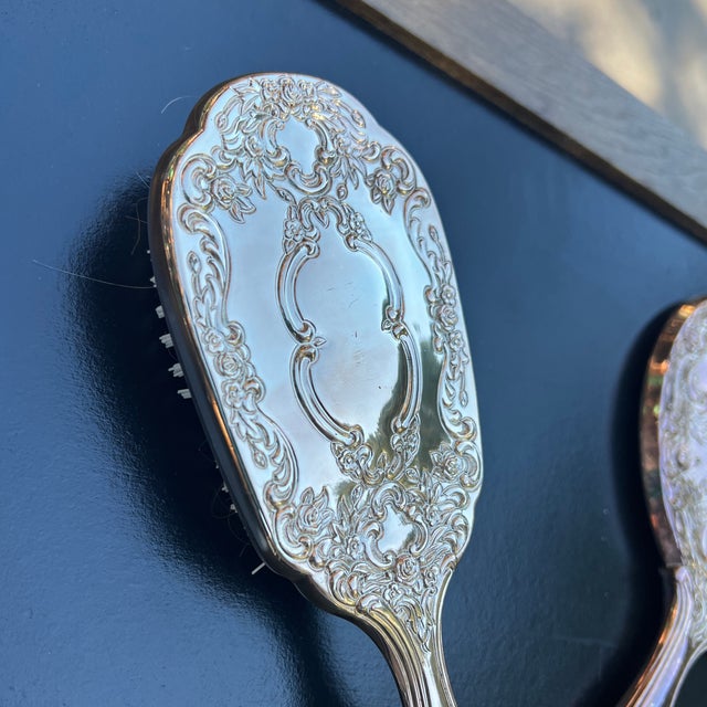 Up for consideration is a beautiful vintage silver plated vanity set including a hand held mirror, brush, and a comb. This...