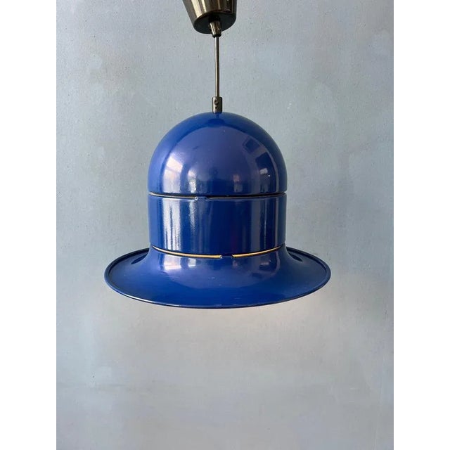 Unique mid century space age pendant light in blue colour. The lamp is made out of metal and has a glossy yellow lacquer....