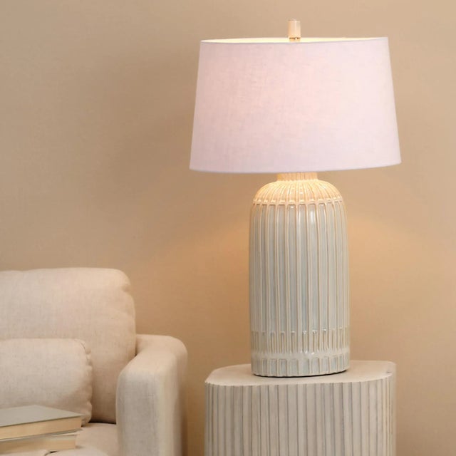European lines are reinterpreted here in an elegant yet easy ceramic table lamp. Touches of hand applied color enhance...