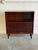 This versatile piece combines an open upper shelf with lower sliding doors for organized storage. Its balanced design...