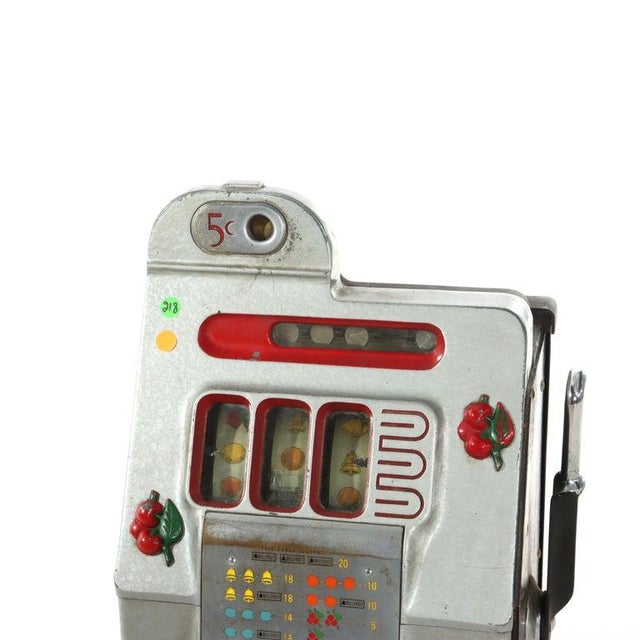 This antique Mills Novelty Co. "Cherry Blossom" 5-cent slot machine is a classic example of early 20th-century arcade and...