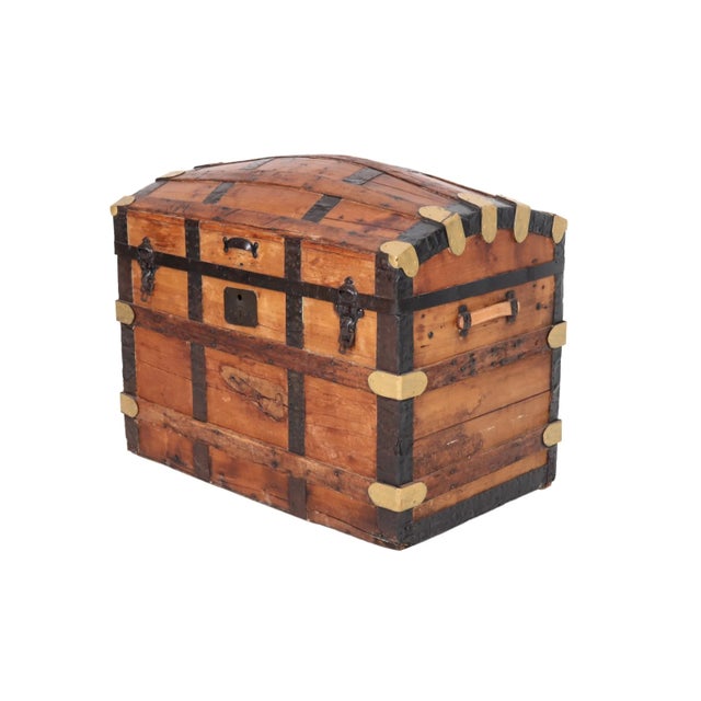 An antique barrel-stave steamer trunk dating from the mid 19th century. Made of oak, it has a domed lid with gold painted...