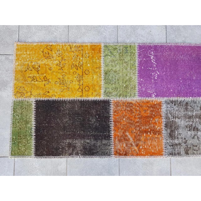 This is a vintage Turkish Oushak rug from the Mid 20th Century. The piece was hand-knotted.