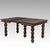 Evoking a sense of moody, historic grandeur, this antique Jacobean Revival draw-leaf dining table features a commanding...