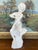 This vintage plaster sculpture presents a seated nude female figure in a delicate, introspective pose, her arms crossing...