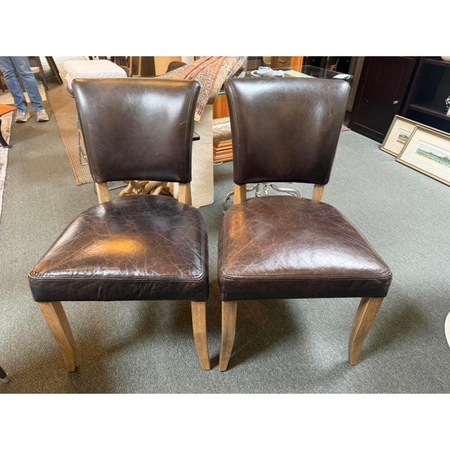 Design Plus Gallery presents a Pair of Four Hands Mimi Side Chairs. The chairs have hand-aged top-grain leather in sleek,...