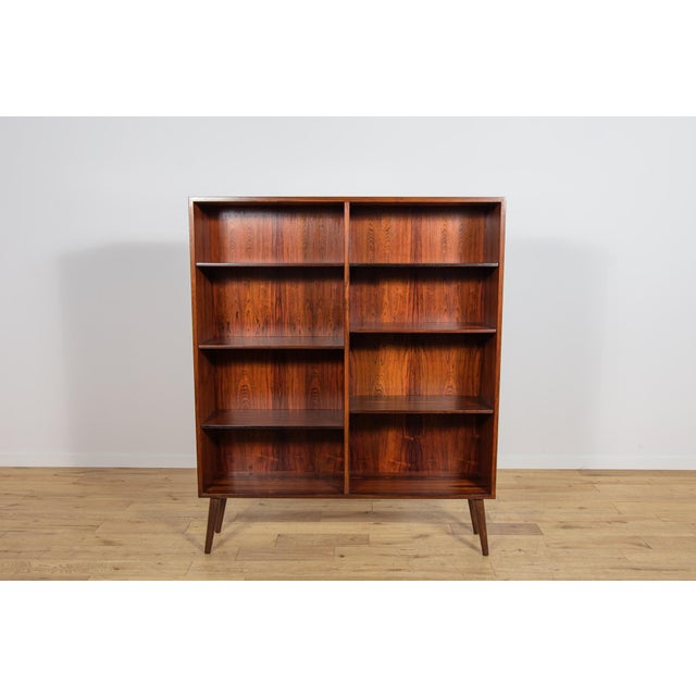This Danish Model 6 bookcase was manufactured by the renowned furniture maker Omann Jun in Denmark during the 1960s. The...