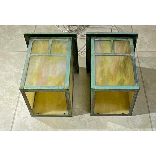 20th century Arts & Crafts pendant light in a lantern design. Features textured beautiful art glass shades , one 60/watt...