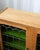 A Danish oak cabinet in the style of Henning Kjærnulf, distinguished by stained glass door panels — a detail that brings...