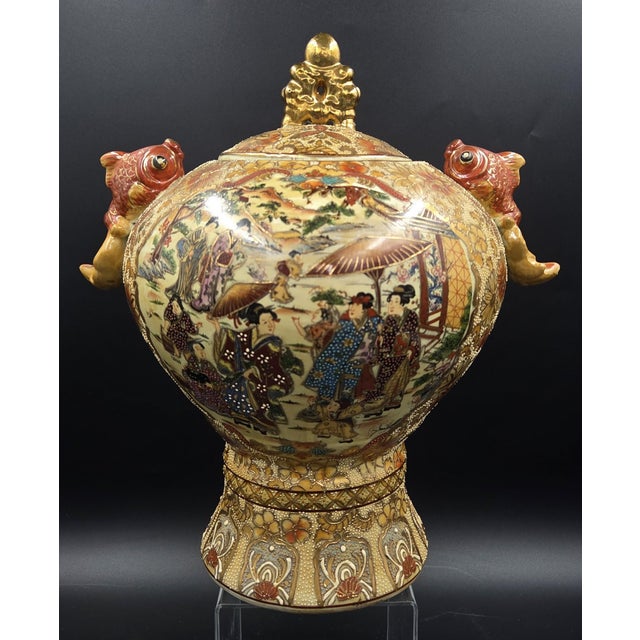 An opulent statement piece of Japanese decorative art, this 14-inch Satsuma-style porcelain urn is a masterclass in the...