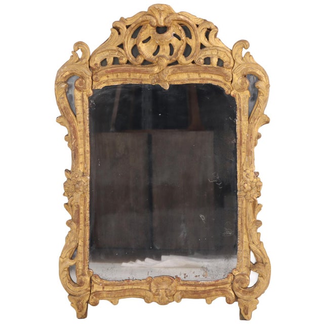 Finely executed in the Rococo taste with an elaborately pierced crest and scrolling foliate ornament, the richly carved...