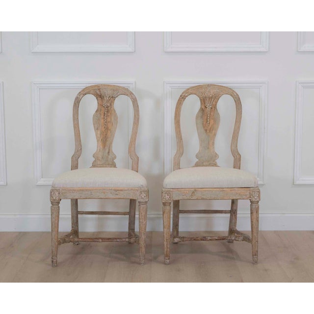 Attractive pair of 19th century Swedish provincial Gustavian chairs featuring elegant lines, scraped original paint, and...