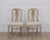 Attractive pair of 19th century Swedish provincial Gustavian chairs featuring elegant lines, scraped original paint, and...