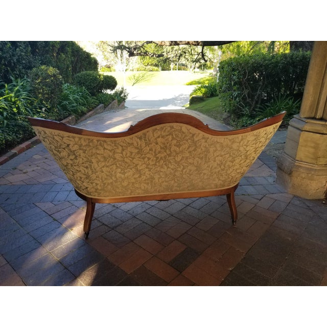 Victorian Loveseat with Wood Walnut Carved Frame . Tufted Upholstery and Casters on feet . The carving is elegant and...