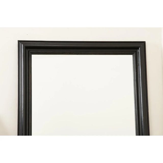 A late 19th century French ebonized wood symmetrical mirror from a bistro, with original glass and an ogee frame. Dating...