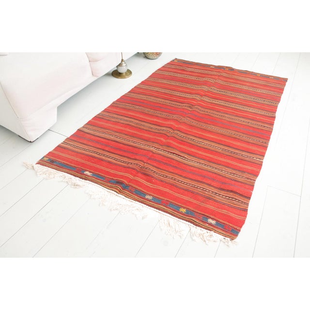 This is a vintage Turkish Oushak rug from the Mid 20th Century. The piece was hand-knotted.