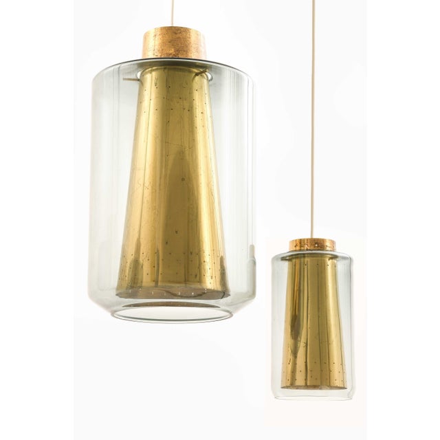 This rare set of three ceiling lamps, produced in Scandinavia—likely during the mid-20th century—offers a refined...